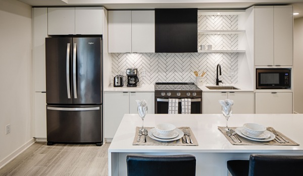 kitchen with stainless steel appliances, island and quartz counters at j sol luxury arlington apartments