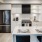 kitchen with stainless steel appliances, island and quartz counters at j sol luxury arlington apartments