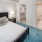 Bedroom with bed, night stands, dresser and view of closet and bathroom at j sol luxury arlington apartments