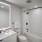 bath with bathtub, toilet, led framed mirror and vanity at j sol luxury arlington apartments