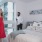 friends chatting in bedroom with floor to ceiling windows, bed, night stands, and modern artwork at j sol luxury arlington apartments
