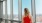 woman in red dress looking over arlington skyline at j sol luxury apartments