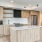 Modern Kitchen With Stainless Steel Appliances, Tan Cabinetry And White Backsplash At J Sol Apartments In Arlington, VA
