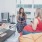 friends chatting on sofa in living area with floor to ceiling windows, coffee table, side chairs and plank flooring at j sol luxury arlington apartments
