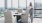 woman checking her phone in the resident sky lounge with leather chairs, social seating, and view of dc at j sol luxury arlington apartments