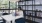 woman working on a laptop in a private work area with meeting table and decorative shelving at j sol luxury apartments in arlington 