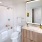 Bathroom With Tub, Toliet, Quartz Vanity And Backlight Mirror At J Sol Apartments In Arlington, VA
