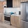 Modern Kitchens With Stainless Steel Appliances With Tan Cabinetry And White Backsplash At J Sol Apartments In Arlington, VA