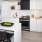 Kitchen With Stainless Steel Appliances, White Cabinetry And White Backsplash At J Sol Apartments In Arlington, VA