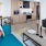 living area with sofa, side tables, coffee table, view of kitchen and modern artwork at j sol