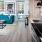 living area with sofa, side tables, coffee table, view of kitchen and modern artwork at j sol