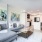 living area with sofa, side tables, coffee table, view of kitchen and modern artwork at j sol